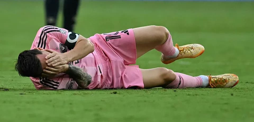 Player lying on the ground holding face in pain
