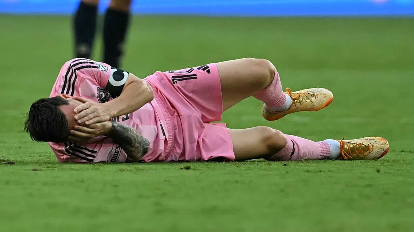 Player lying on the ground holding face in pain