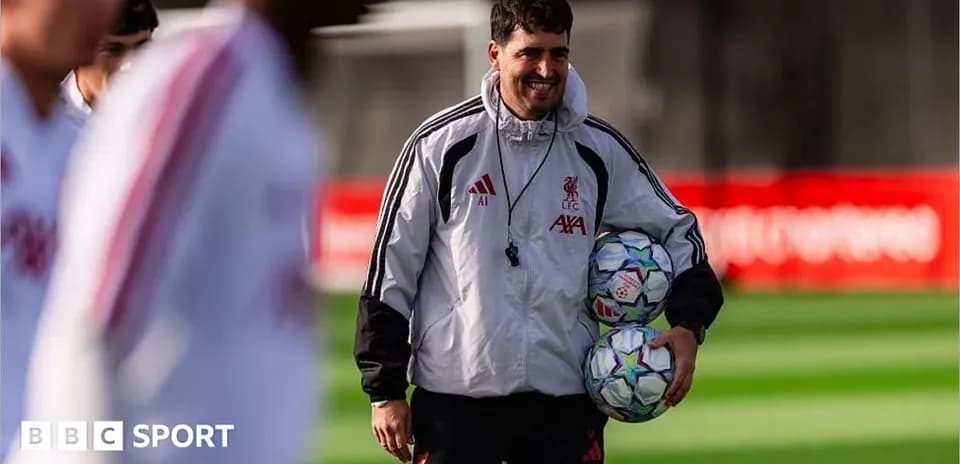 An official holding footballs during training session