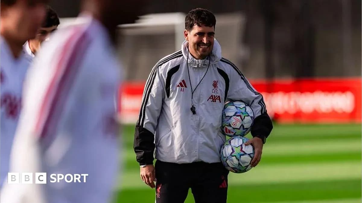 An official holding footballs during training session