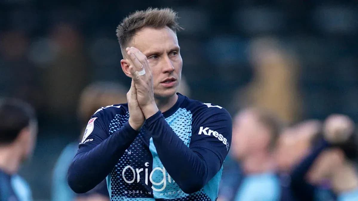 Goalkeeper applauding fans after the match