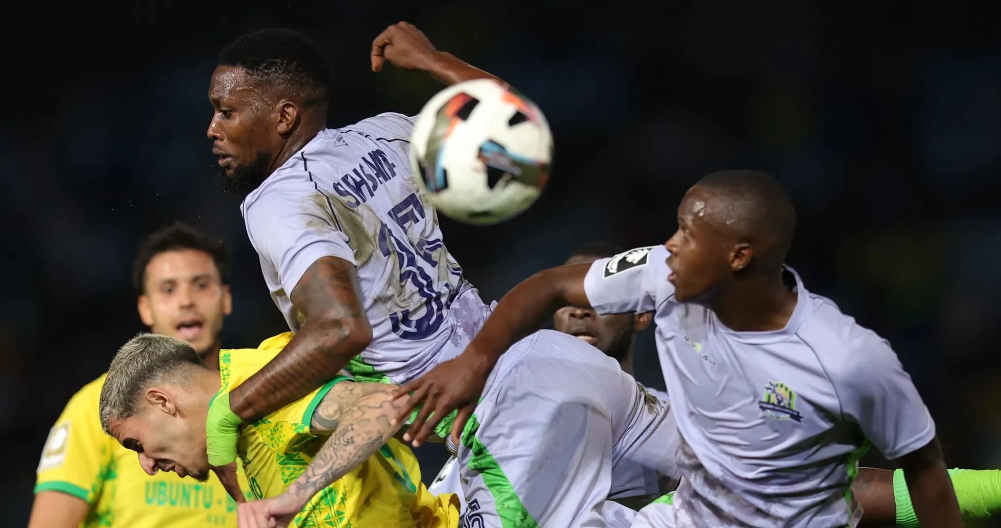 Players contesting the ball during a football match