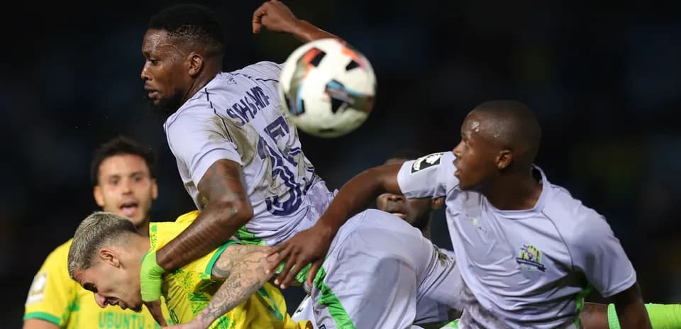 Players contesting the ball during a football match