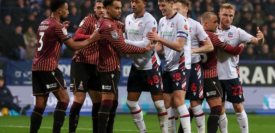 Players from both teams confronting each other during match