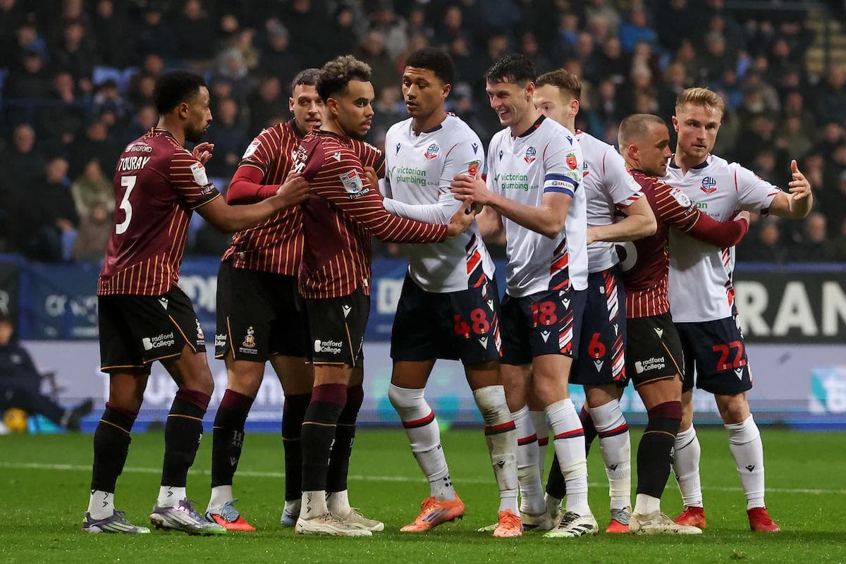 Players from both teams confronting each other during match