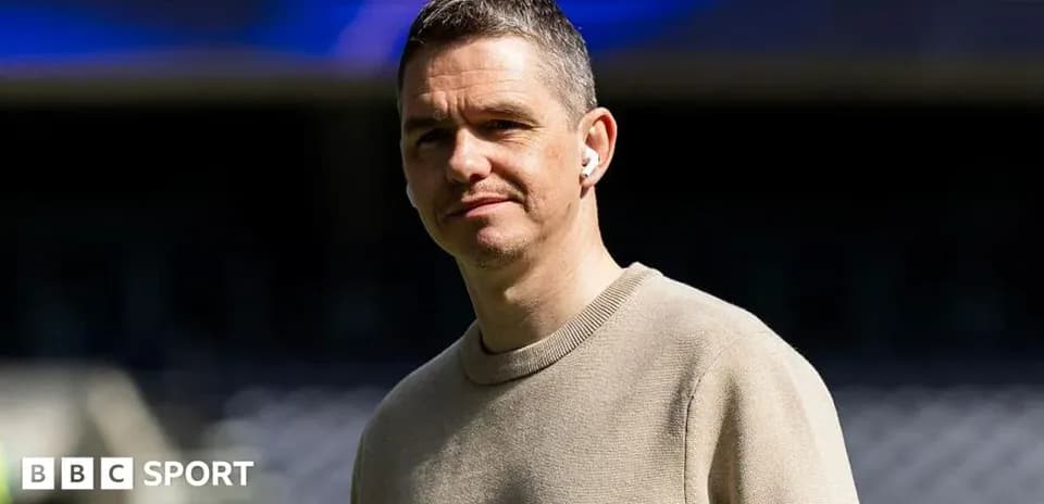 Person with earbuds standing in stadium