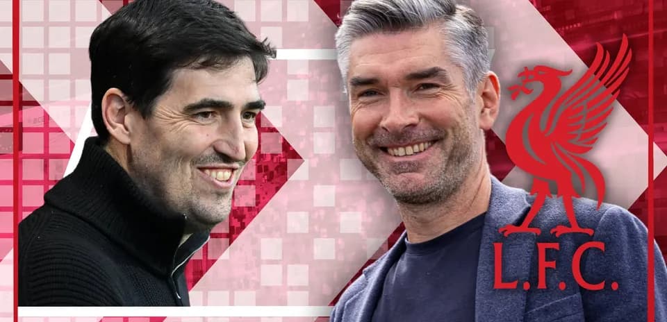 Two coaches smiling with Liverpool logo background
