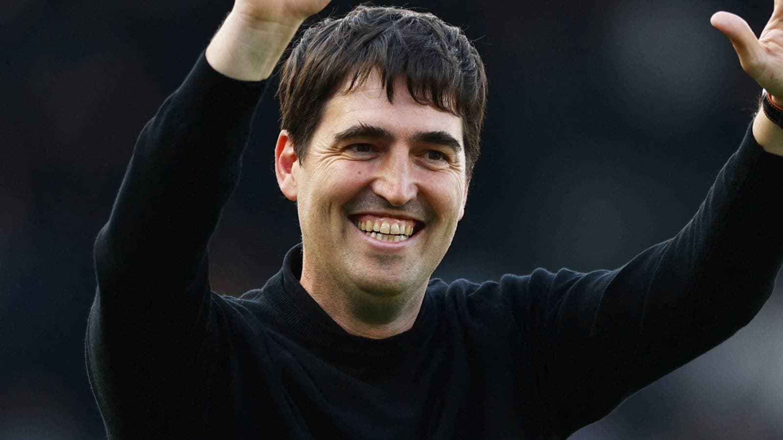 Coach celebrating with raised hand during match