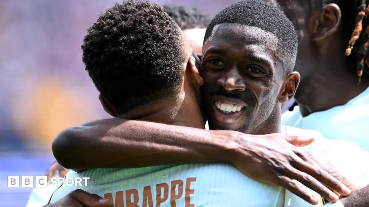 Two players celebrating with a hug on the field