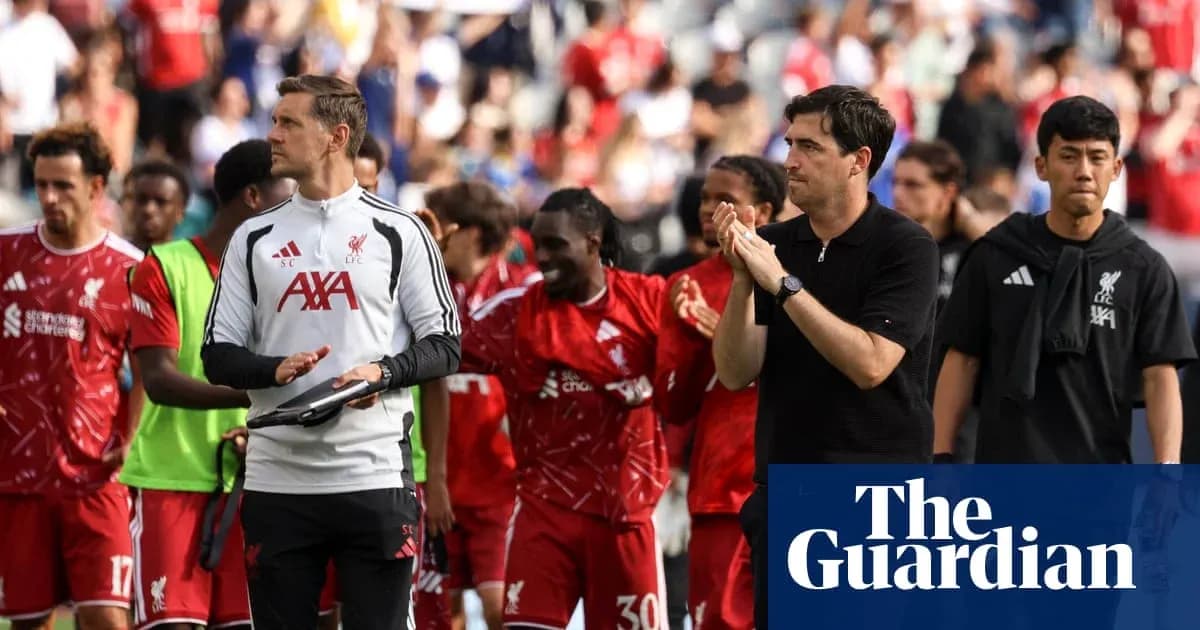 Liverpool players and staff leaving the pitch after match
