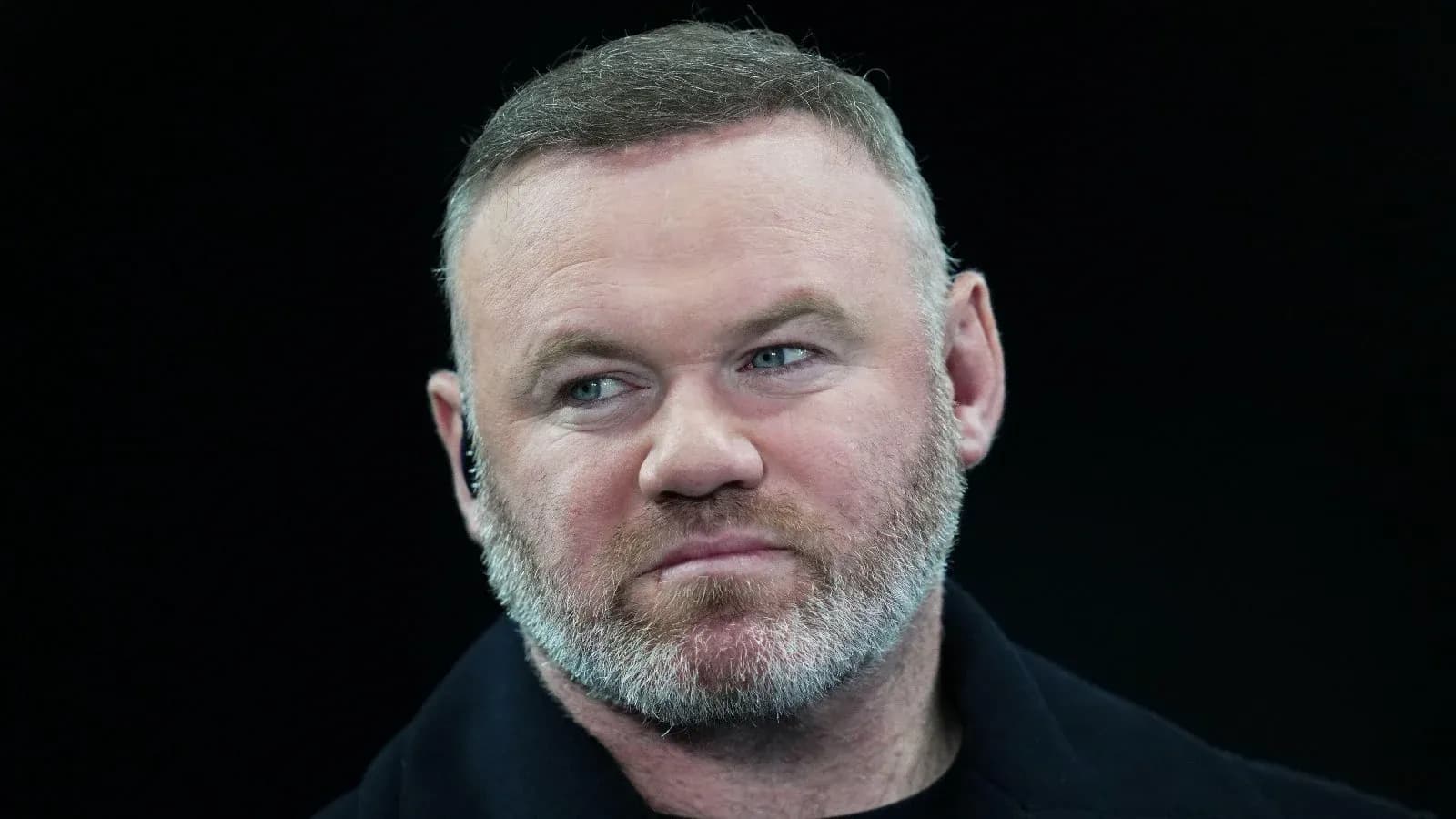 Close-up of a man with a beard and headset