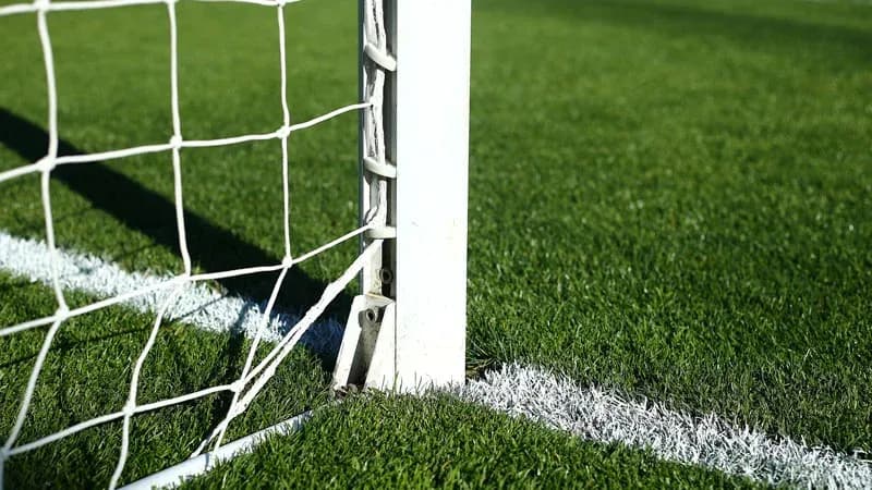 Close-up of soccer goalpost and net corner
