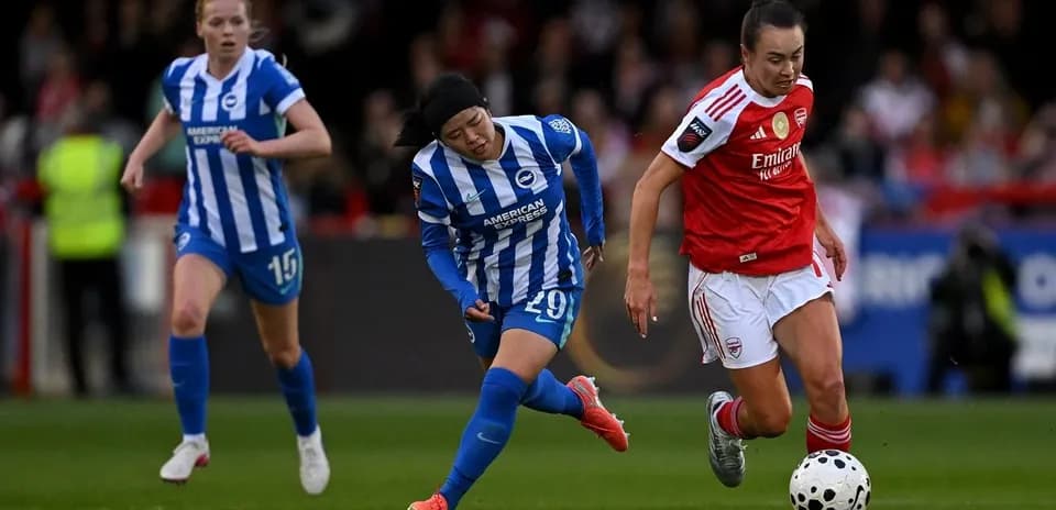 Two players competing for the ball in match
