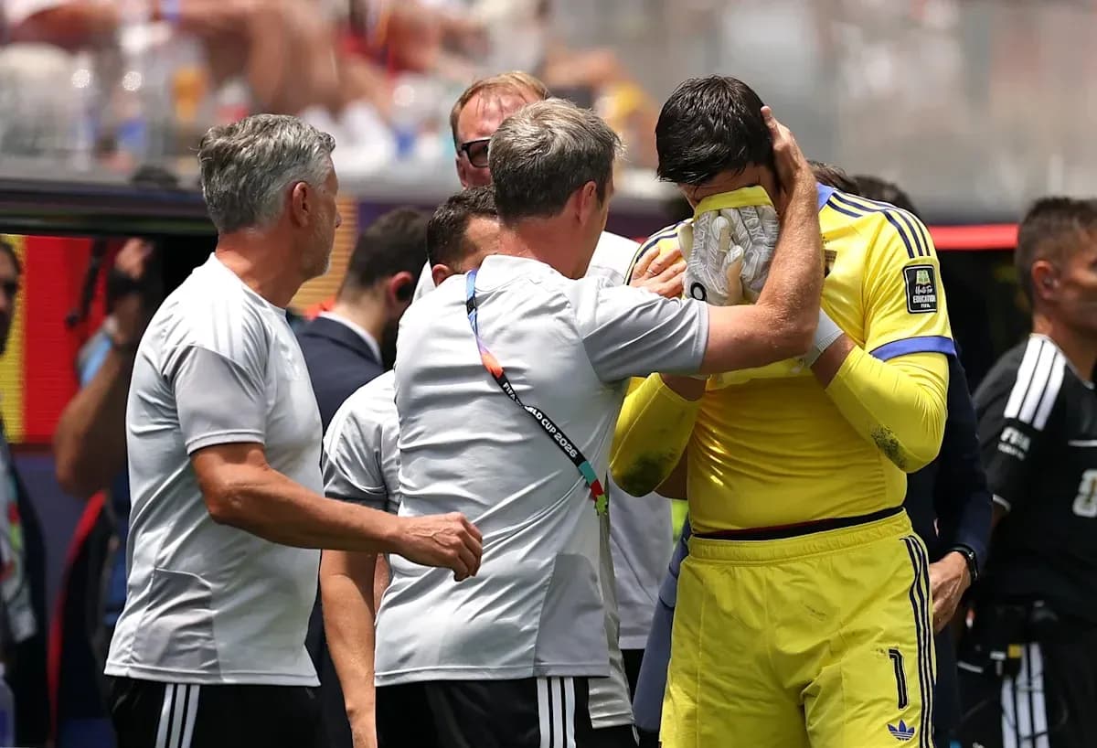 Coach comforting goalkeeper during match break