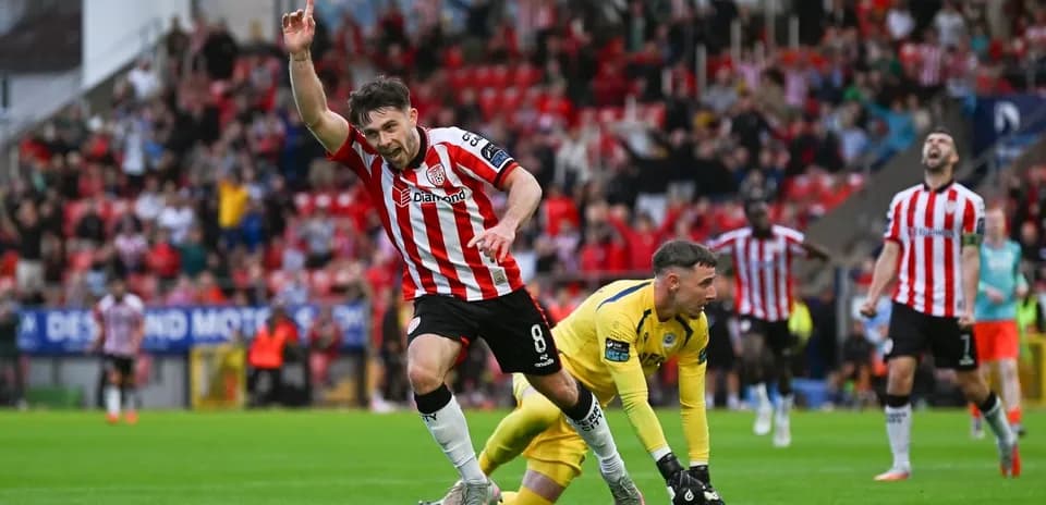 Player celebrating a goal with fans in background