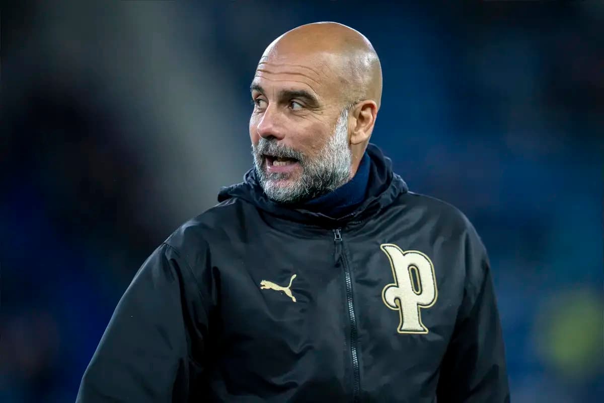 Football coach wearing team jacket on the pitch