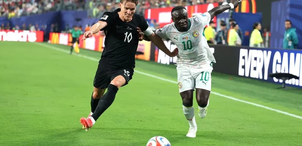 Two players contesting the ball on the field