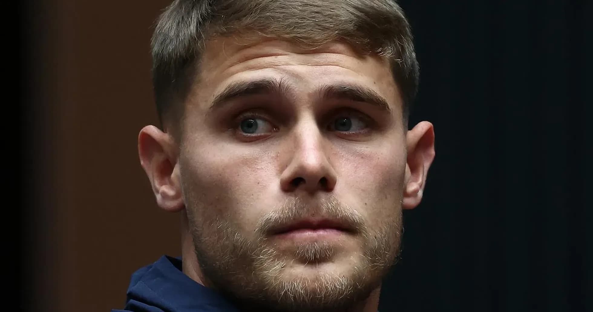 Player wearing Tottenham jacket during event