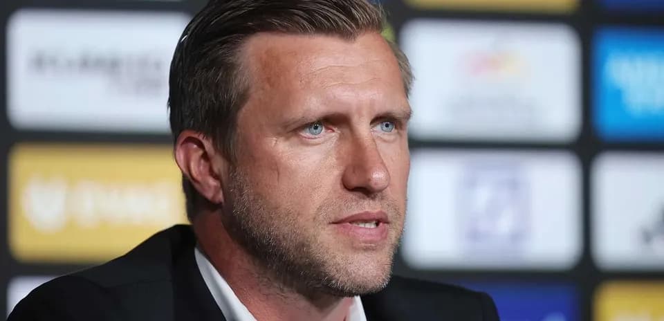 Men's football manager speaking at press conference