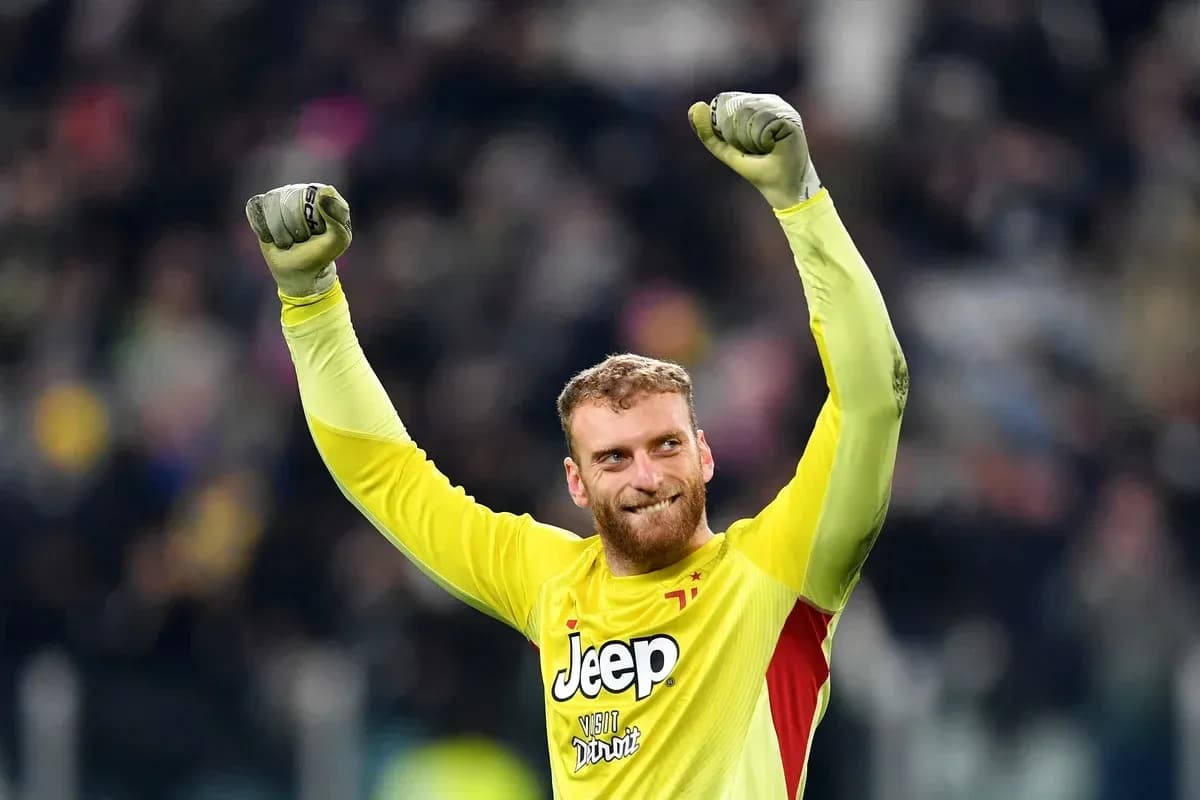 Goalkeeper celebrating victory with raised arms