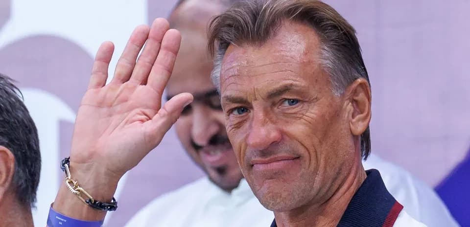 Coach waving during an event or press conference