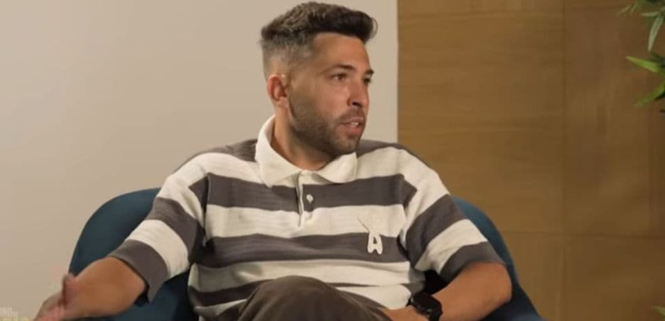 Man speaking during an interview on a couch