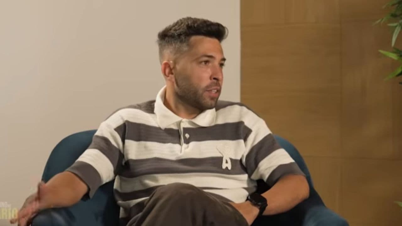 Man speaking during an interview on a couch