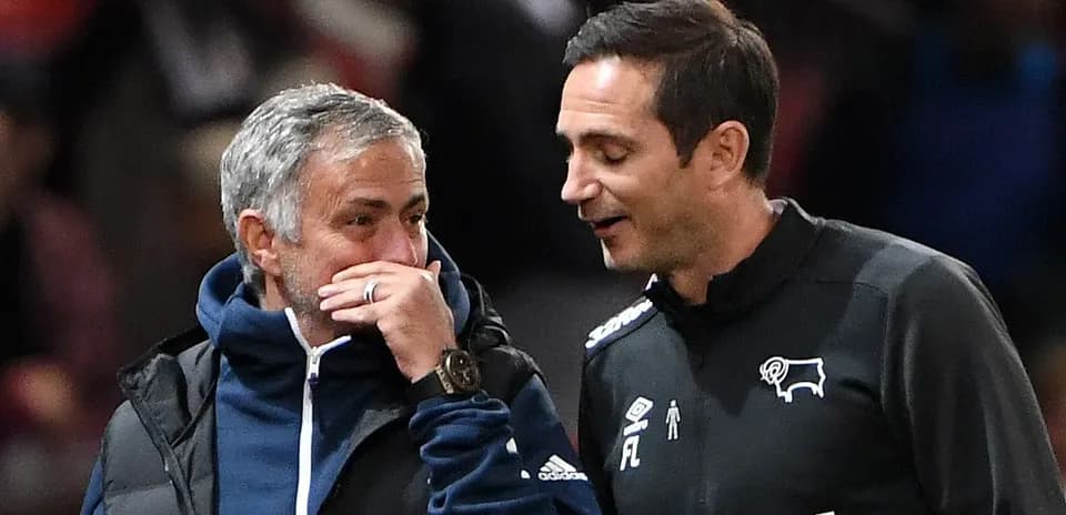 Two coaches discussing on the sidelines during match