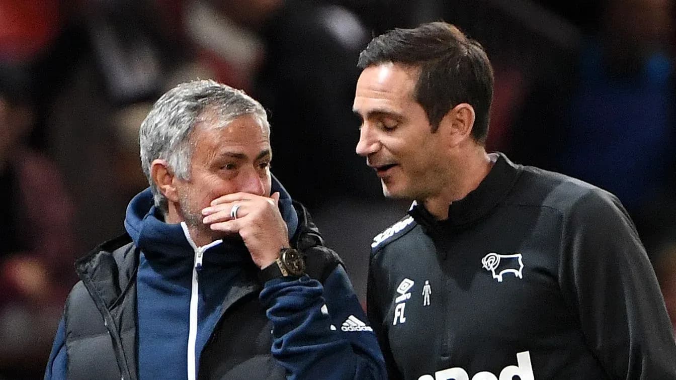 Two coaches discussing on the sidelines during match