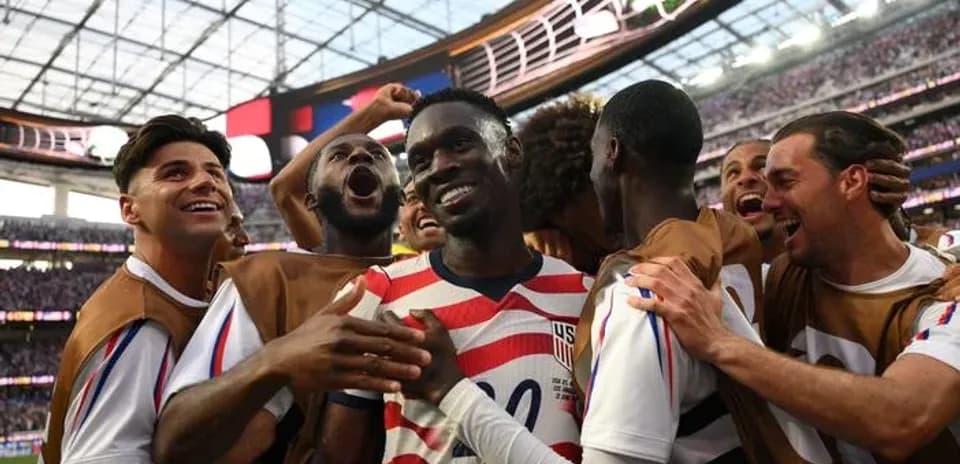 US team celebrating after scoring a goal