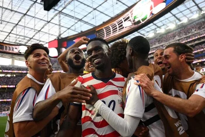 US team celebrating after scoring a goal