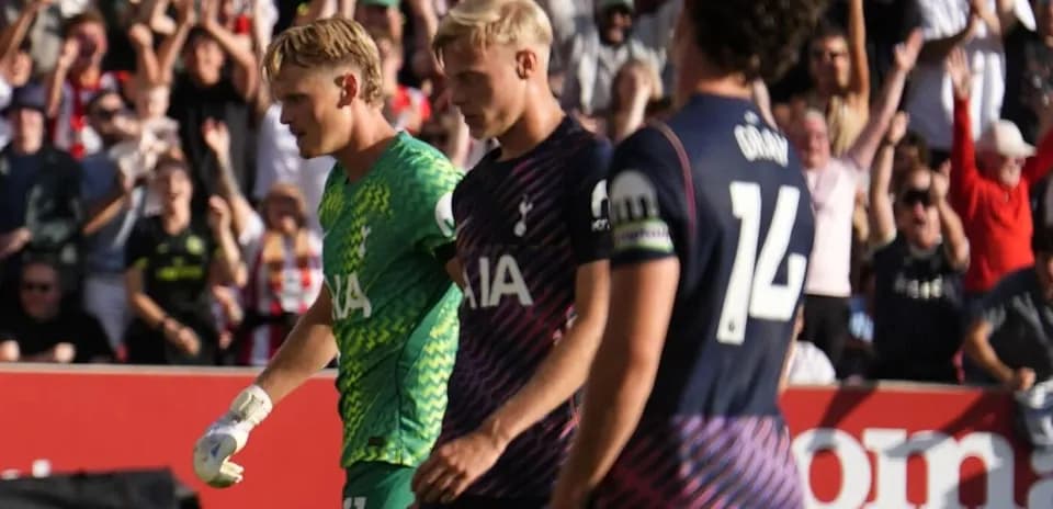 Goalkeeper and players walking off the pitch