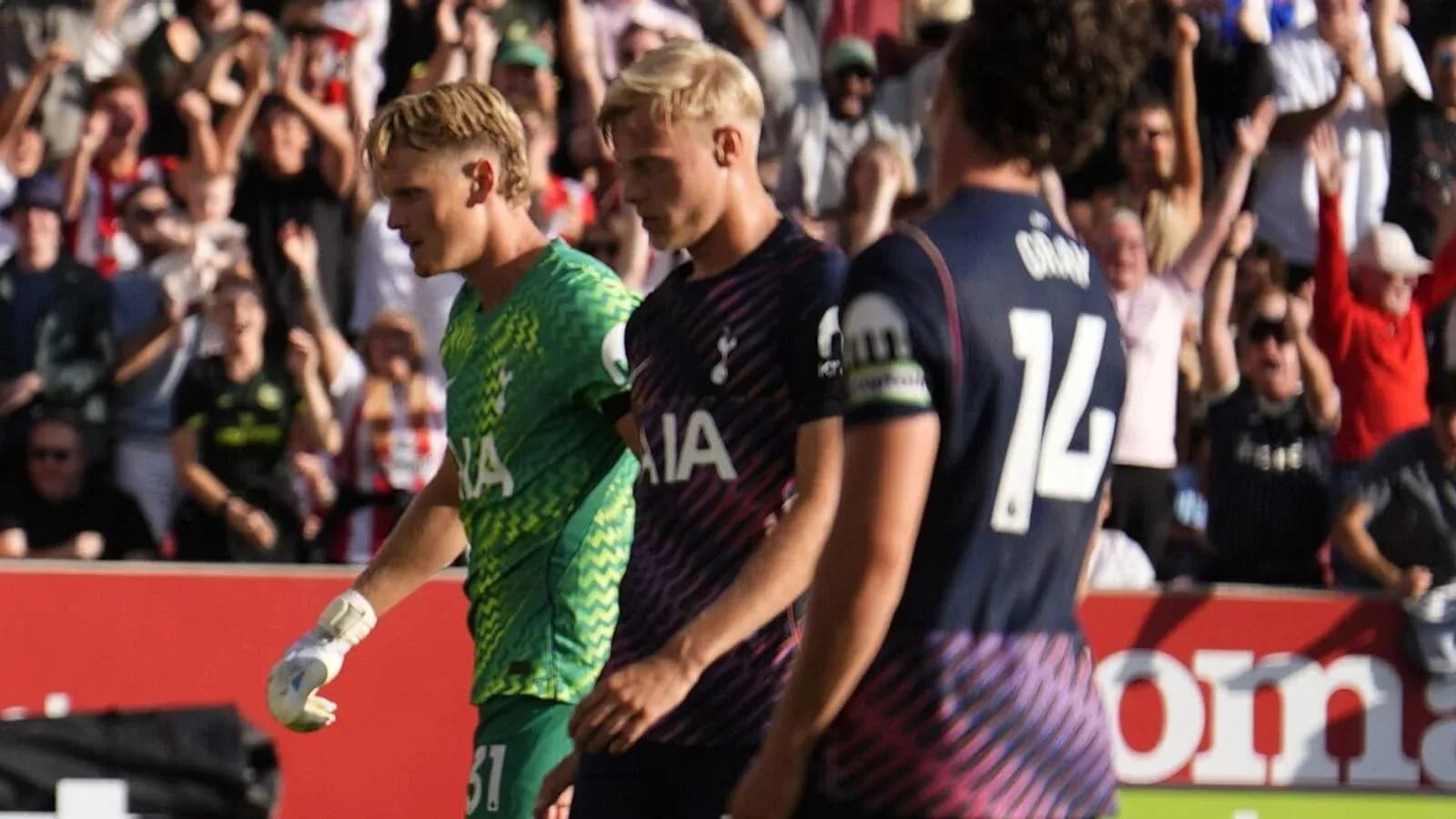 Goalkeeper and players walking off the pitch