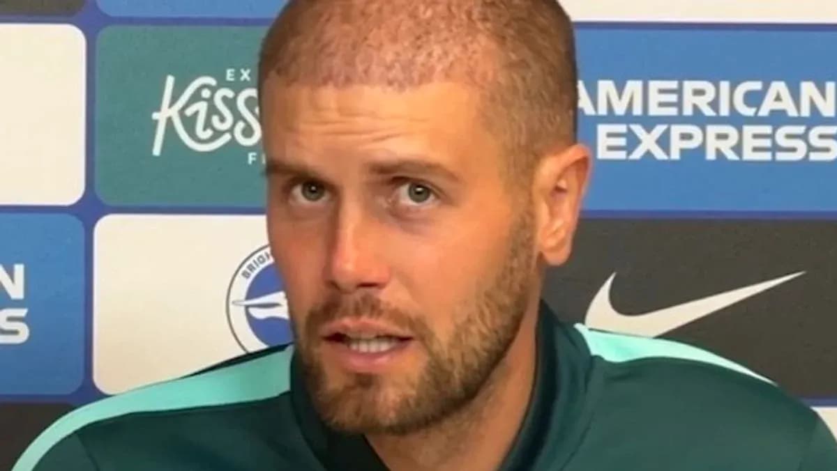 Football manager speaking at press conference podium