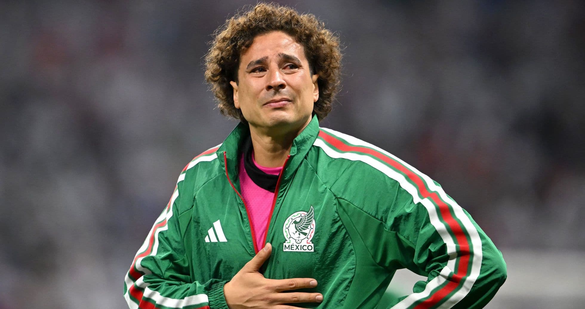 Goalkeeper in green jacket during match celebration