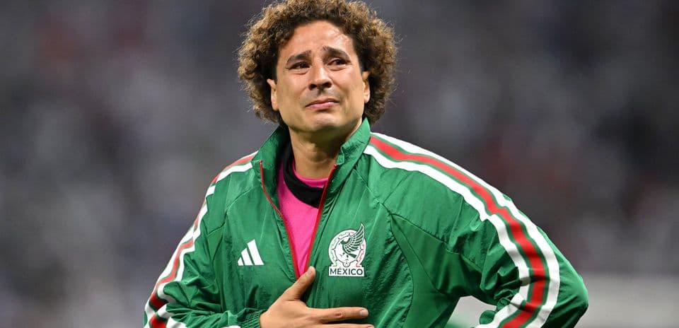 Goalkeeper in green jacket during match celebration