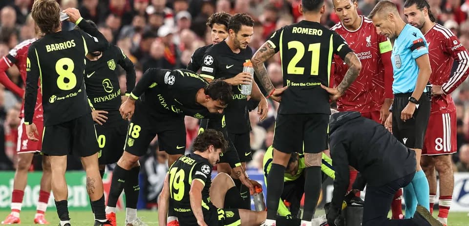 Atletico Madrid players gather around injured teammate