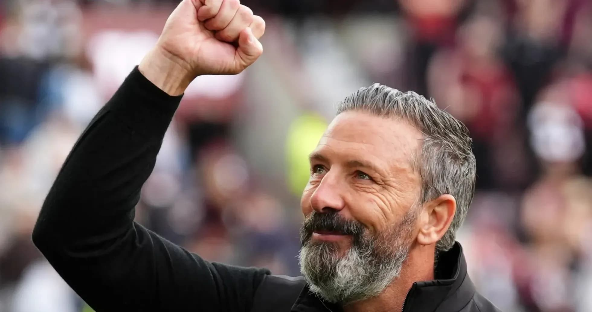 Coach celebrating with raised fist during match