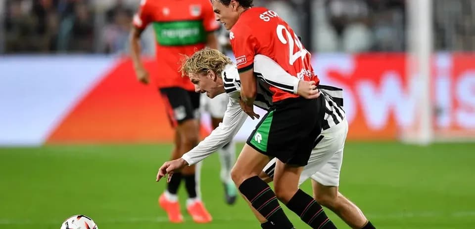Two players battling for the ball during match