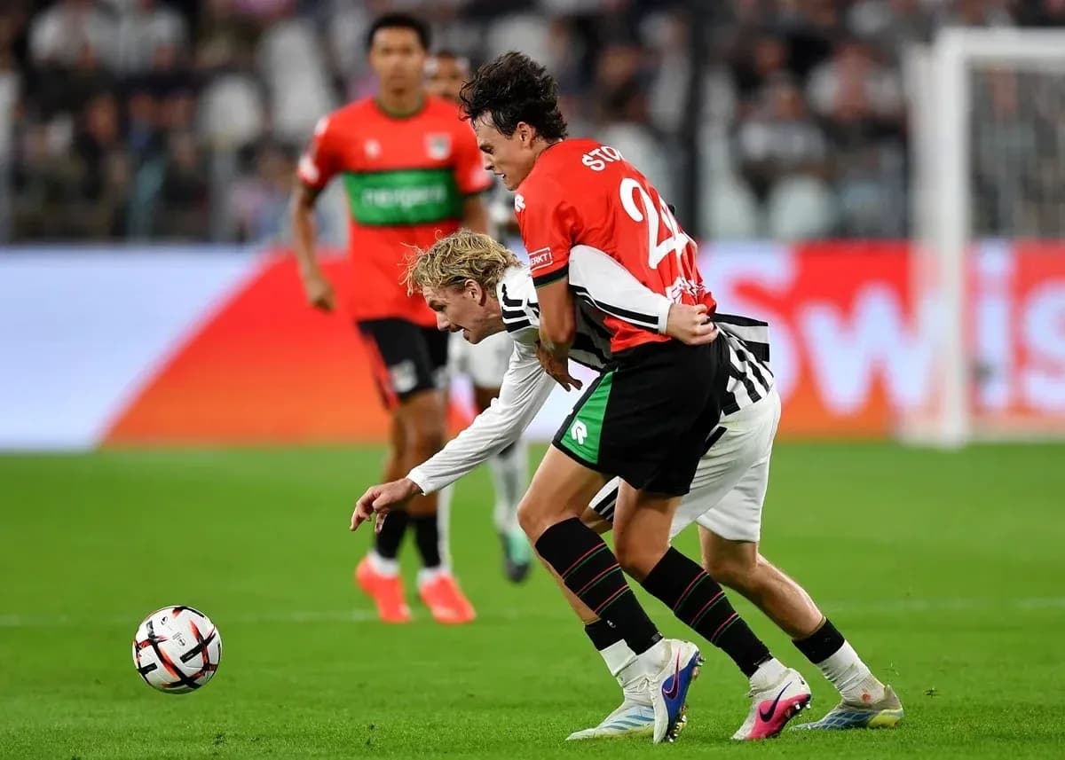 Two players battling for the ball during match