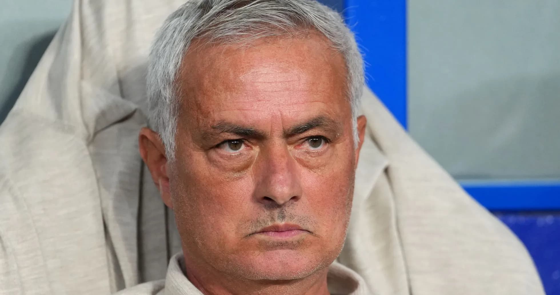 Manager sitting on the bench during a match