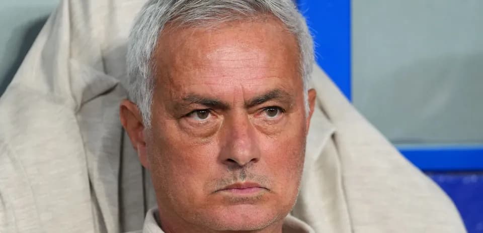 Manager sitting on the bench during a match