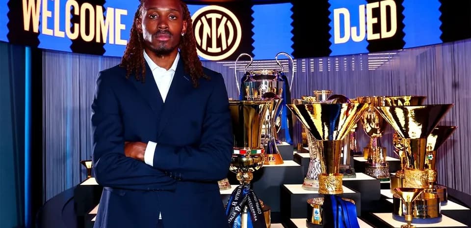 New player posing with trophies at presentation event