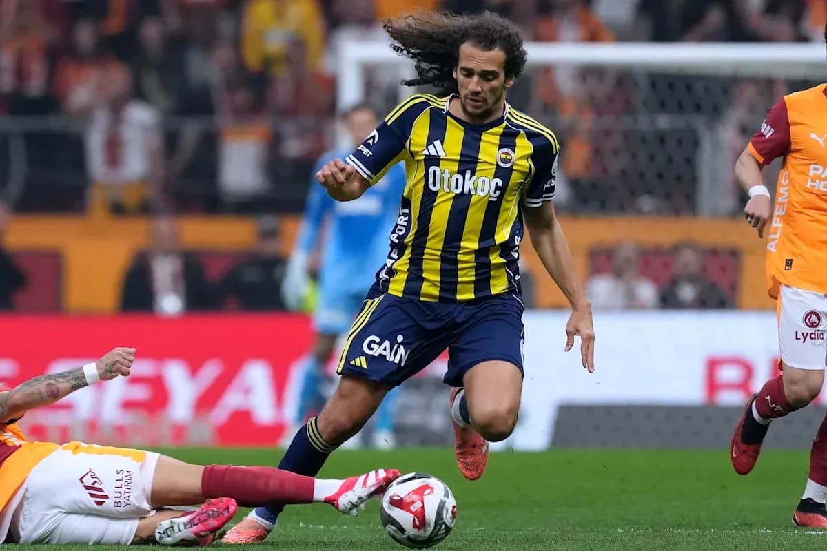 Fenerbahçe player dribbling past opponent during match