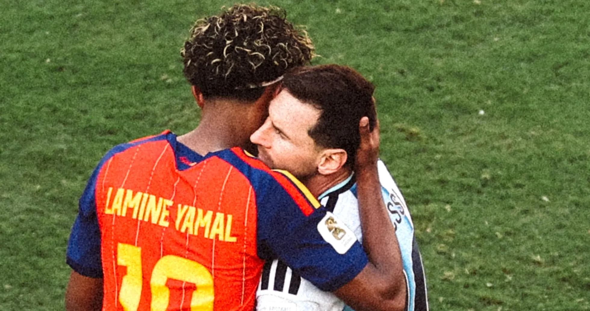 Lamine Yamal and Lionel Messi embracing on field