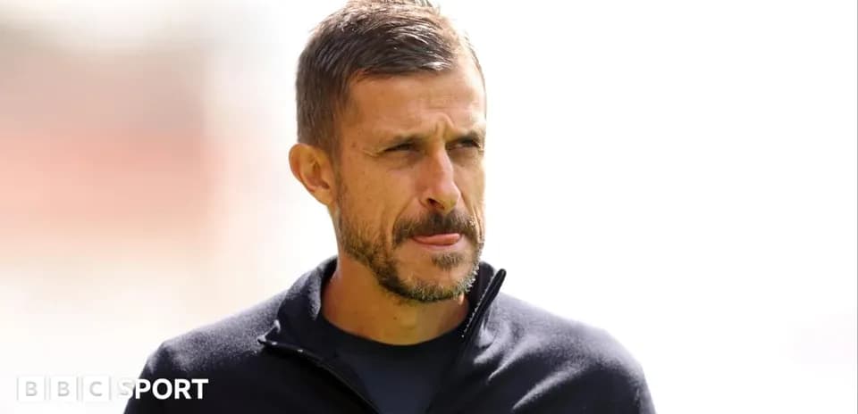 Men's football coach on the sidelines during match
