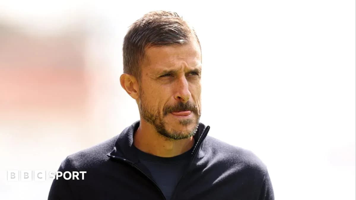 Men's football coach on the sidelines during match