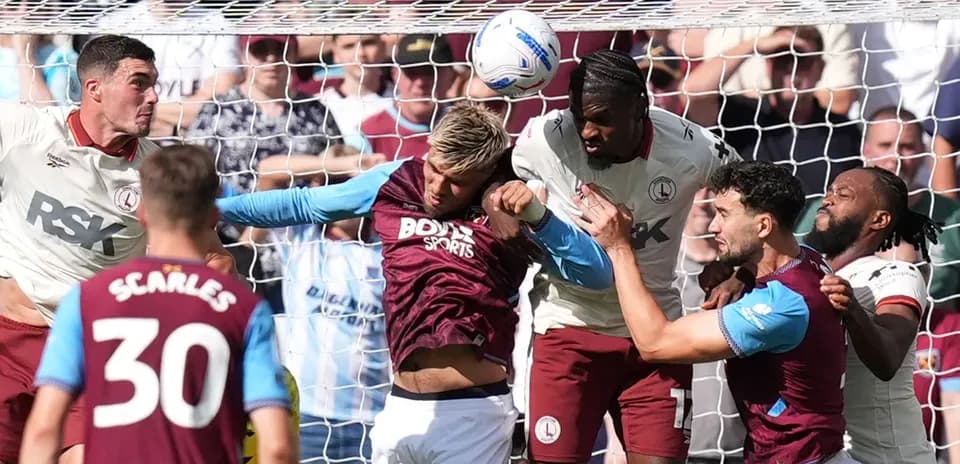 Players contesting for the ball in front of goal