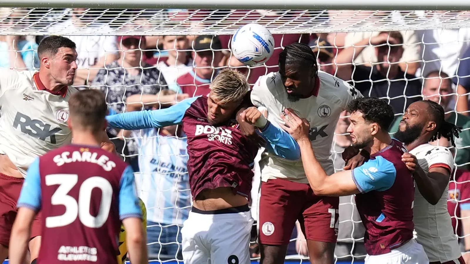Players contesting for the ball in front of goal