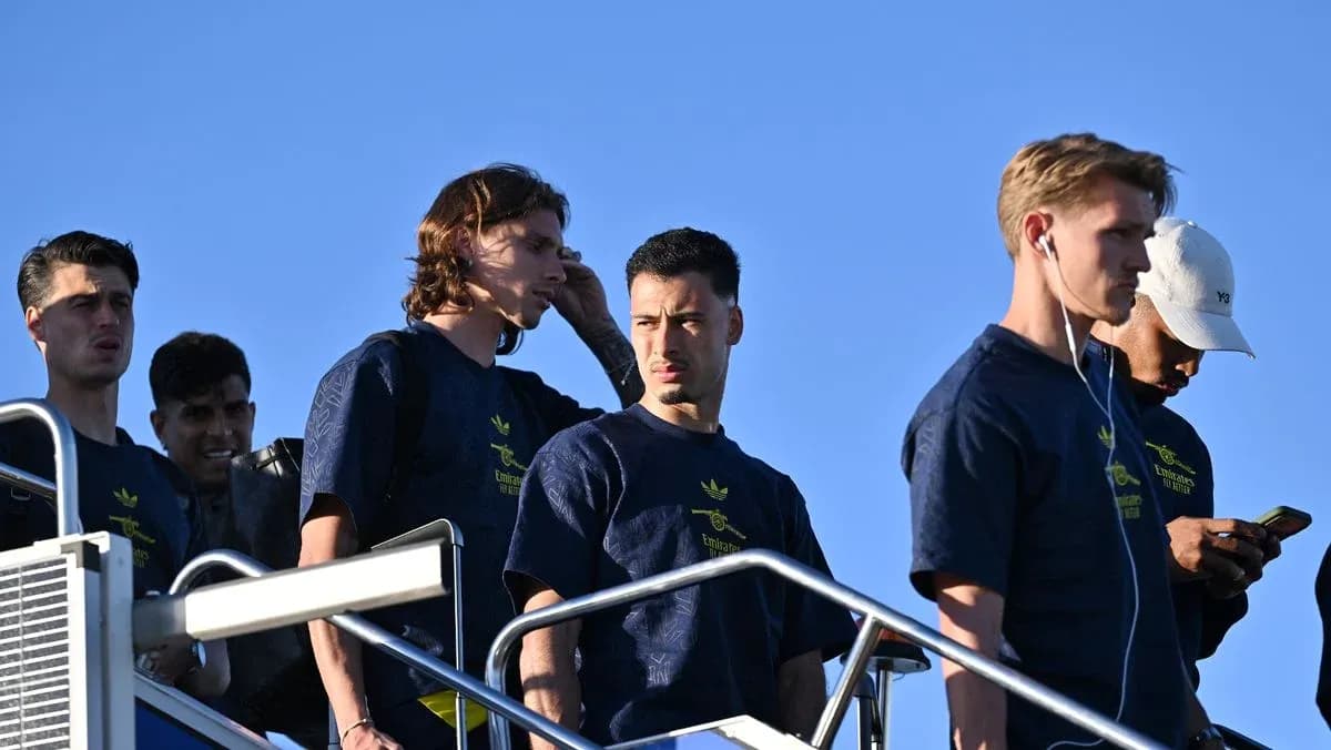 Players descending stairs in team attire outdoors